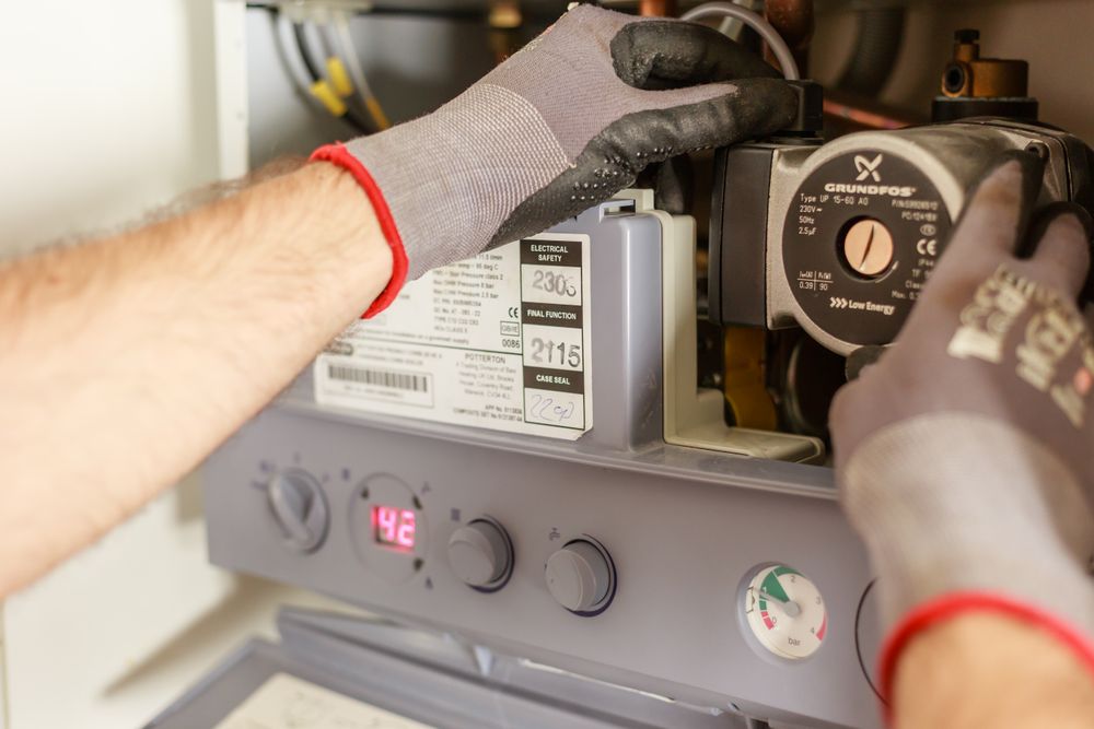 Close-up of a heating engineer servicing plumbing equipment